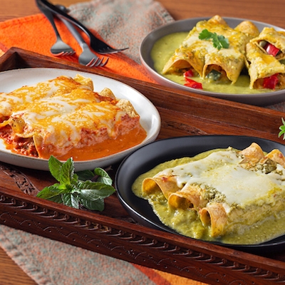 enchiladas served in colorful plates on an ethnic tablecloth