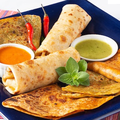 quesadillas served with green and red sauce on a blue plate