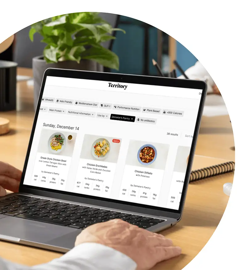 Laptop displaying the Territory meal management platform for prepared meal programs.