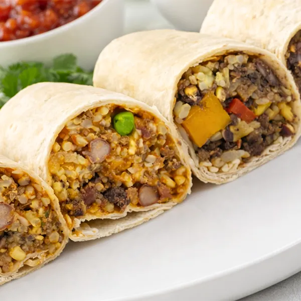 Latin-style burrito wrap filled with grains, beans, and vegetables prepared for healthy meal delivery.