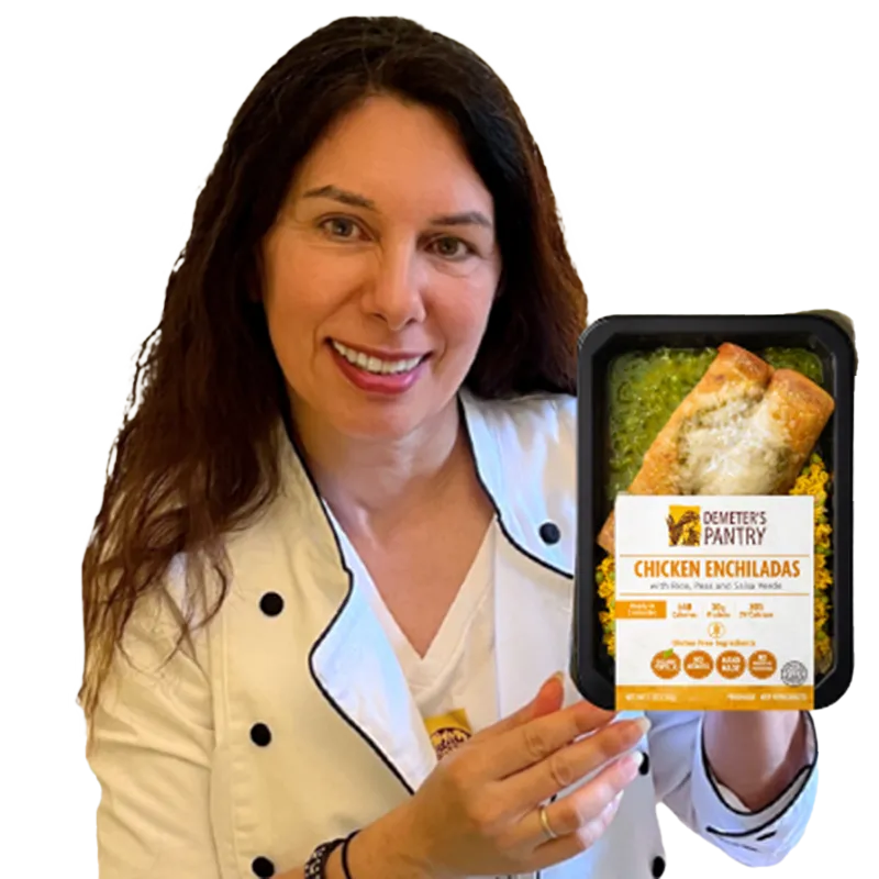 Chef holding a prepared Mediterranean meal product made with natural ingredients.