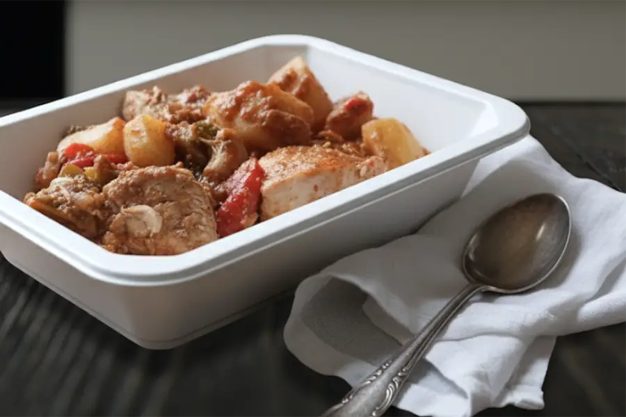 Mediterranean chicken stew with potatoes and vegetables served in a ready to eat tray