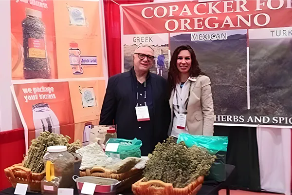 Herb supplier booth showcasing dried oregano and Mediterranean herbs at a food industry trade show.