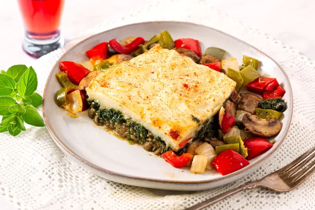 Mediterranean lentil and spinach shepherd’s pie served with grilled vegetables.
