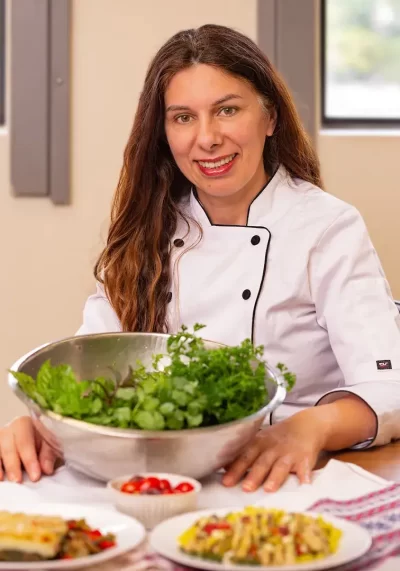 Maria Kardamaki posing with her favorite herbs for her recipes